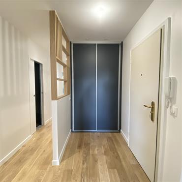 Cloison avec un claustra en chêne intégré, pour délimiter l'entrée du reste de l'espace.  