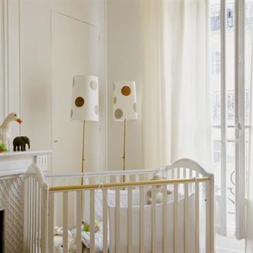Chambre de bébé aux tons doux avec rideaux blancs