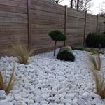 Jardin paysagé moderne avec galets et conifères nains